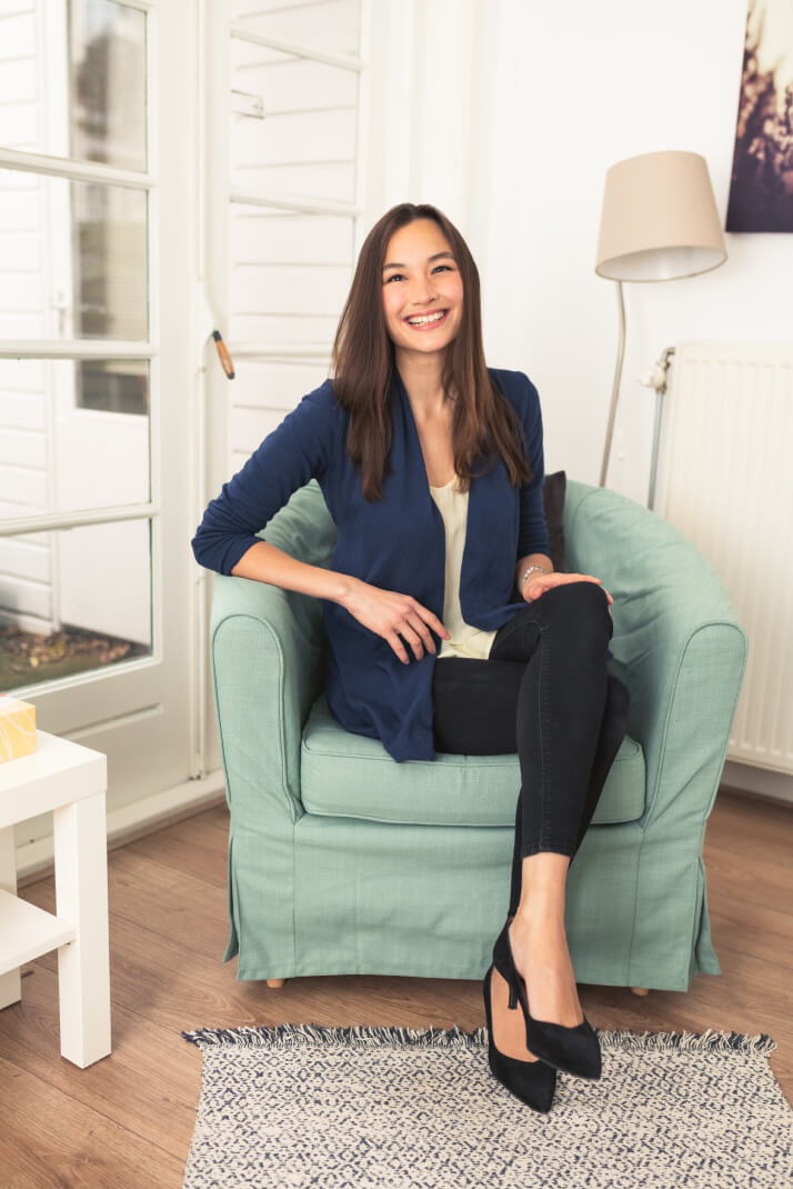 Diana Orlando Van Walsum sitting on a chair smiling